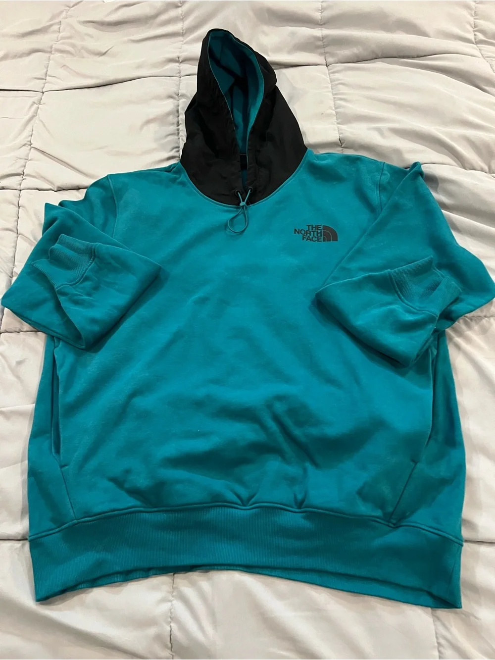 The North Face  Me's Teal Hoodie pullover with Black Hood snd pockets size XL.